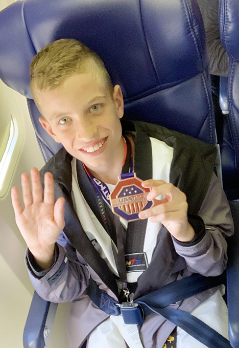 Charlie Flies Home with Black Belt and Team Medal